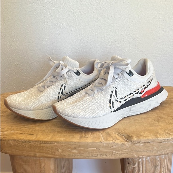 Nike Shoes - Women’s Nike React Flyknit White Athletic Sneakers with Accent Details